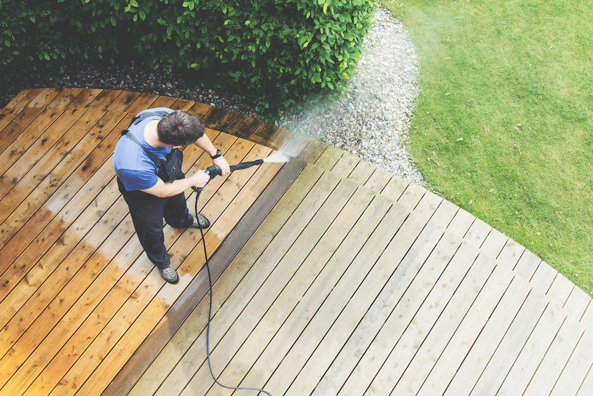 man cleaning decking