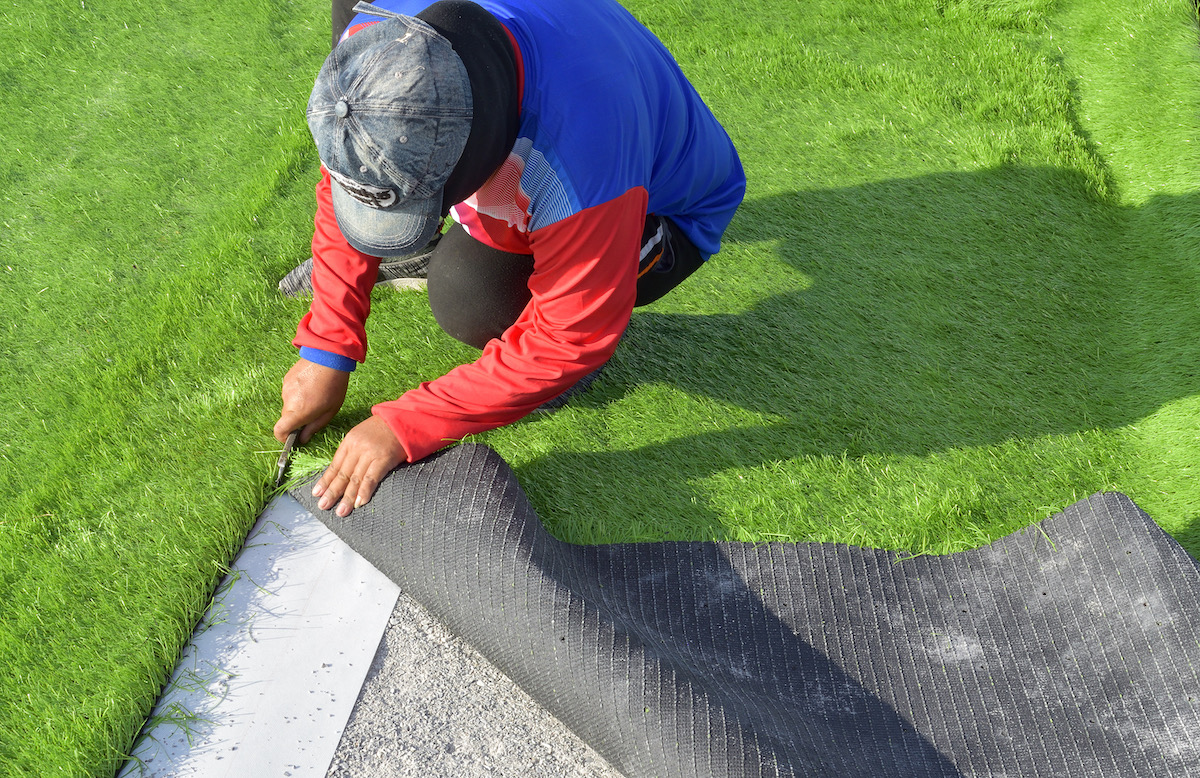 man laying artificial grass.jpg